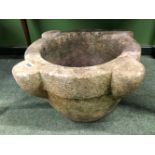 A MARBLE MORTAR WITH A ROUNDED BASE, THE RIM WITH FOUR THREE QUARTER ROUND BOSSES. W 53cms.