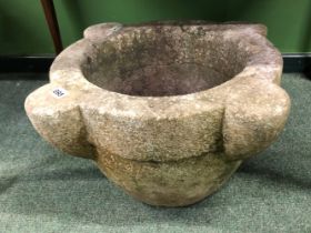 A MARBLE MORTAR WITH A ROUNDED BASE, THE RIM WITH FOUR THREE QUARTER ROUND BOSSES. W 53cms.