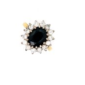 AN 18ct HALLMARKED GOLD, SAPPHIRE AND DIAMOND CLUSTER RING. THE OVAL SAPPHIRE APPROX DIMENSIONS 10.5