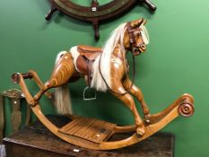 A WAYSIDE ROCKERS OF EVESHAM ROCKING HORSE CARVED FROM BONDED SLICES OF DARK AND LIGHT WOOD, THE