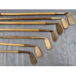 A BAG OF EIGHT HICKORY SHAFTED GOLF IRONS