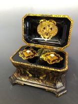 A VICTORIAN JENNENS AND BETTRIDGE GEOMETRICALLY GILT BLACK PAPIER MACHE TWO COMPARTMENT TEA CADDY