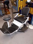 A FULLY ADJUSTABLE BLACK UPHOLSTERED WHITE ENAMELLED DENTISTS CHAIR WITH ACCOMPANYING STANDARD