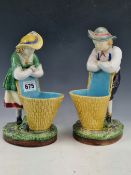 A PAIR OF MINTON MAJOLICA FIGURAL SWEETMEATS, DATE CODE FOR 1883, THE MALE AND FEMALE FIGURE LEAN ON