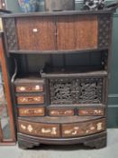 A JAPANESE CABINET WITH A BOW FRONTED TAMBOUR ENCLOSED SHELF TOP OVER DRAWERS WITH INLAID TEA POTS