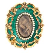 A VICTORIAN GUILLOCHE GREEN ENAMEL MOURNING BROOCH SET WITH WOVEN HAIR AND A SEED PEARL SURROUND.