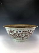 A CHINESE UNDERGLAZE RED BOWL, THE EXTERIOR PAINTED WITH DRAGONS, THE INTERIOR WITH A COFFEE BROWN
