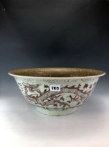 A CHINESE UNDERGLAZE RED BOWL, THE EXTERIOR PAINTED WITH DRAGONS, THE INTERIOR WITH A COFFEE BROWN