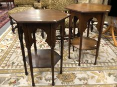 A PAIR OF ARTS AND CRAFTS OAK HEXAGONAL TABLES WITH OGEE ARCHED APRONS AT THE TOP OF CYLINDRICAL