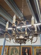 A SIX LIGHT CANDLE FORM CHANDELIER HUNG FROM HOOPED ARMS, THE CENTRAL COLUMN WITH A GLASS BOWL