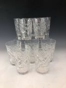 A SET OF TEN GLASS TUMBLERS, EACH WITH DIAMOND DIAPER CUT CYLINDRICAL SIDES TAPERING FACETTED FEET