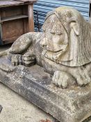 AN IMPRESSIVE PAIR OF LARGE WEATHERED COMPOSITE STONE STONE RECLINING LIONS. W 153cms.
