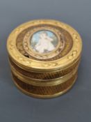 A GOLD MOUNTED PATCH BOX, THE CIRCULAR LID INSET WITH AN OVAL MINIATURE, THE GOLD BANDS WITH PAIRS