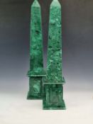 A PAIR OF MALACHITE OBELISKS OF SQUARE SECTION FLARING TO BASES APPLIED WITH RECTANGULAR TABLETS.