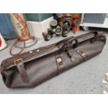 A VICTORIAN LEATHER CRICKET BAG SECURED BY A BRASS LOCK AND THREE STRAPS, A PAIR OF LEATHER BOUND