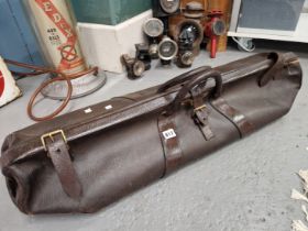 A VICTORIAN LEATHER CRICKET BAG SECURED BY A BRASS LOCK AND THREE STRAPS, A PAIR OF LEATHER BOUND