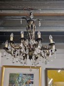 A GILT METAL TWO TIER CHANDELIER, THE FOLIATE SUPPORTING COLUMN ENDING IN A BOWL SHAPE MOUNTED