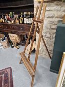 A VICTORIAN MAHOGANY ARTISTS EASEL, THE PICTURE RESTING TROUGH. W 52cms.