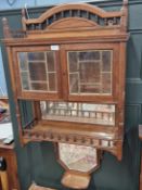 AN ARTS AND CRAFTS MAHOGANY WALL UNIT WITH TWO LEADED GLASS DOORS OVER TWO MIRROR BACKED OPEN