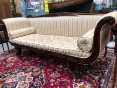 A VICTORIAN MAHOGANY SHOW FRAME SETTEE, THE FRONTS OF THE OUTWARDLY SCROLLING ARMS CARVED WITH