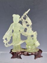 A CHINESE BOWENITE CARVING, WOOD STAND AND FITTED BOX, THE TRANSLUCENT GREEN STONE CARVED AS A