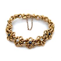 A VINTAGE 15ct GOLD, SAPPHIRE AND DIAMOND WOVEN FLORAL BRACELET. THE BRACELET FITTED WITH AN