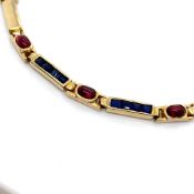 A SAPPHIRE AND RUBY SET PANEL BRACELET. THE BRACELET UNHALLMARKED, STAMPED 585, ASSESSED AS 14ct