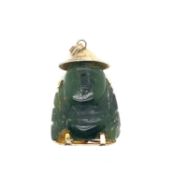 A NEPHRITE JADE CARVED BUDDHA PENDANT FITTED WITH A GOLD PLATED COVER WITH CHARACTER MARKS AND