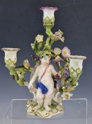 ATTRIBUTED TO 18th C. BOW, A THREE LIGHT CANDELABRUM WITH A PUTTO HARVESTING GRAPES BELOW THE