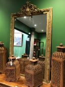 A FRENCH RECTANGULAR MIRROR WITHIN A GILT FOLIAGE SCROLL BANDED FRAME CRESTED BY AN ANTHEMION AMONGS