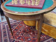 A 19th C. MAHOGANY DEMILUNE BRASS EDGED TRIPLE TOP GAMES AND TEA TABLE ON TAPERING SQUARE LEGS. W