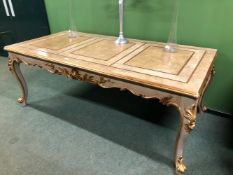 A CREAM GROUND CENTRE TABLE DETAILED IN GILT, THE RECTANGULAR TOP OVER A SHELL CENTRED SCROLLING