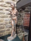 A COPPER PATINATED PLASTER FIGURE OF A FEMALE NUDE STANDING WITH HANDS CLASPED BEHIND HER BACK. H