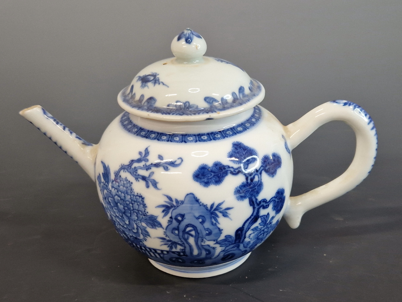A CHINESE BLUE AND WHITE TEA POT AND COVER PAINTED ON EACH SIDE WITH PINE AND PEONY GROWING BY A - Image 2 of 5