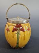 DOULTON?- AN ART NOUVEAU BISCUIT BARREL WITH SILVER PLATED MOUNTS. YELLOW GROUND BODY WITH