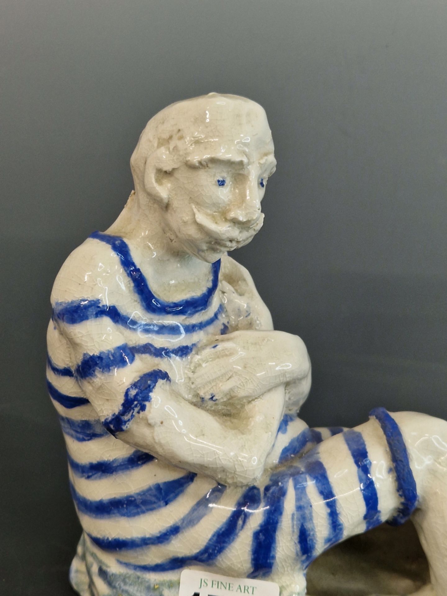 A STUDIO POTTERY FIGURE OF A MAN SEATED WEARING A BLUE STRIPED BATHING SUIT. W 22cms. - Image 2 of 4