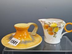 A SHELLEY TONED ORANGE CHAMBER STICK TOGETHER WITH A CREAM JUG WITH ORANGE AND YELLOW DAISIES