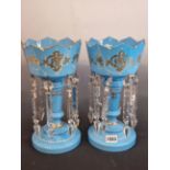 A PAIR OF LATE 19th C. BOHEMIAN SKY BLUE GLASS LUSTRES, THE CROWN TOPS GILT WITH SCROLL BANDS ABOVE