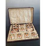 A CASED SET OF SIX CROWN DERBY 6041 IMARI PALETTE COFFEE CANS AND SAUCERS