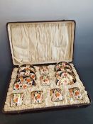 A CASED SET OF SIX CROWN DERBY 6041 IMARI PALETTE COFFEE CANS AND SAUCERS