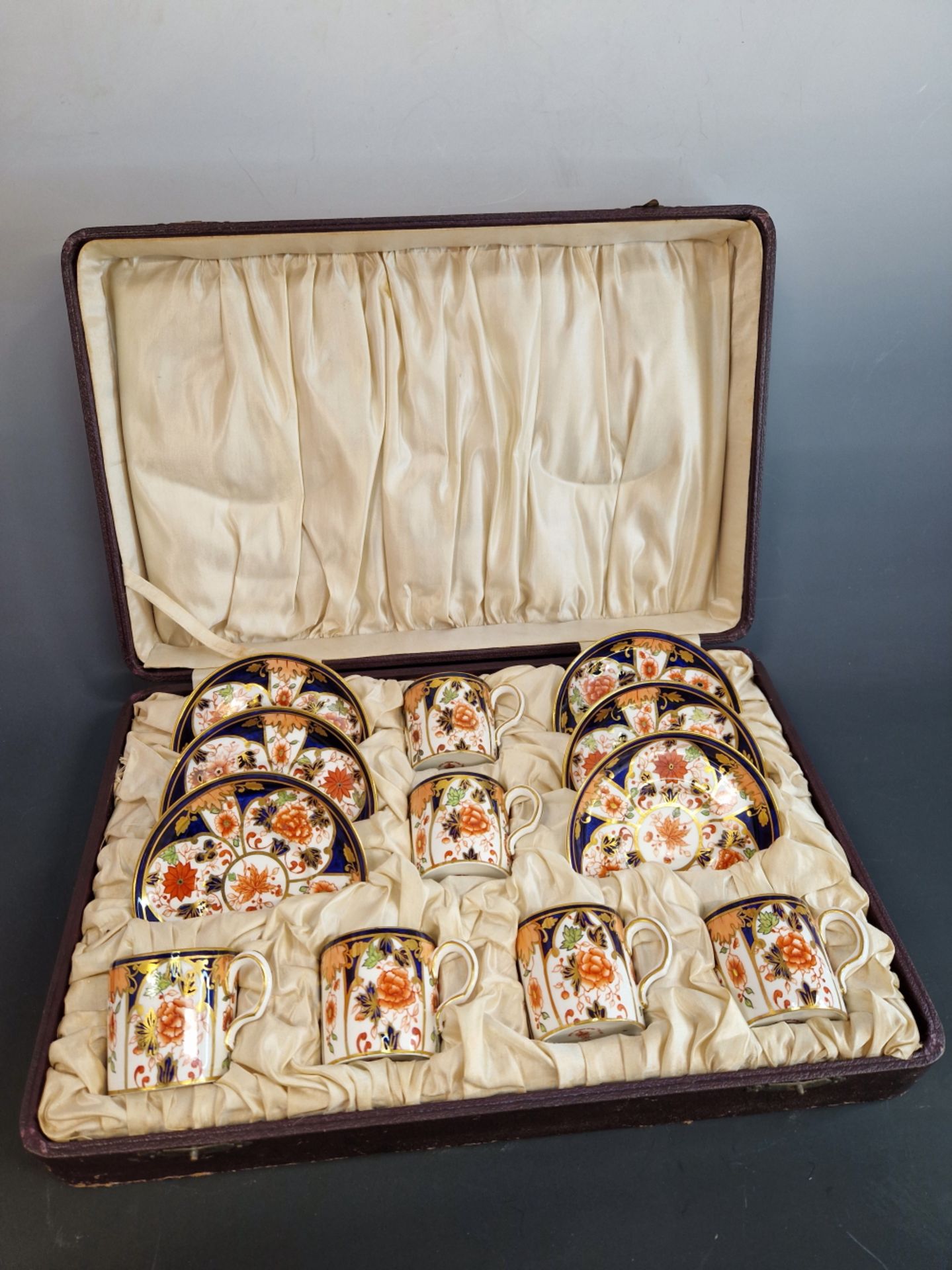 A CASED SET OF SIX CROWN DERBY 6041 IMARI PALETTE COFFEE CANS AND SAUCERS