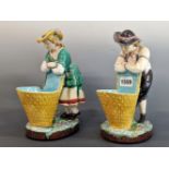 A PAIR OF MINTON MAJOLICA FIGURAL SWEETMEATS, DATE SYMBOL FOR 1870, THE MALE AND FEMALE IN 18th C.