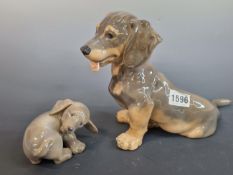 ROYAL COPENHAGEN- A PORCELAIN FIGURE OF A SEATED PUPPY NUMBERED 856. 18 cm HIGH. TOGETHER WITH A
