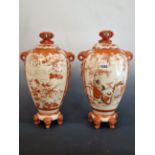 A PAIR OF JAPANESE KUTANI VASES AND COVERS, EACH PAINTED ON ONE SIDE OF THE TASSELLED ELEPHANT