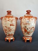 A PAIR OF JAPANESE KUTANI VASES AND COVERS, EACH PAINTED ON ONE SIDE OF THE TASSELLED ELEPHANT