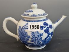 A CHINESE BLUE AND WHITE TEA POT AND COVER PAINTED ON EACH SIDE WITH PINE AND PEONY GROWING BY A