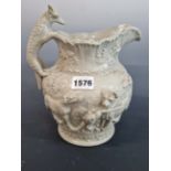 A 19THCENTURY GREY POTTERY RELIEF MOULDED JUG DECORATED WITH FOX FAMILY AND HOUNDS. 22 cm HIGH.