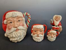 ROYAL DOULTON, SANTA CLAUS. A GRADUATED GROUP OF THREE CHARACTER JUGS TOGETHER WITH A FATHER