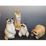 THREE LOMONOSOV PORCELAIN RACOONS TOGETHER WITH A FIGURE OF A LYNX. H 21cms.