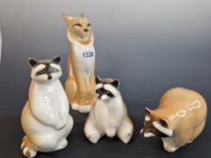 THREE LOMONOSOV PORCELAIN RACOONS TOGETHER WITH A FIGURE OF A LYNX. H 21cms.